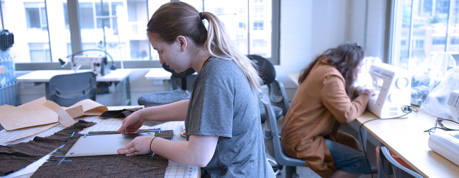 Design students using the lab, sewing and working with fabric