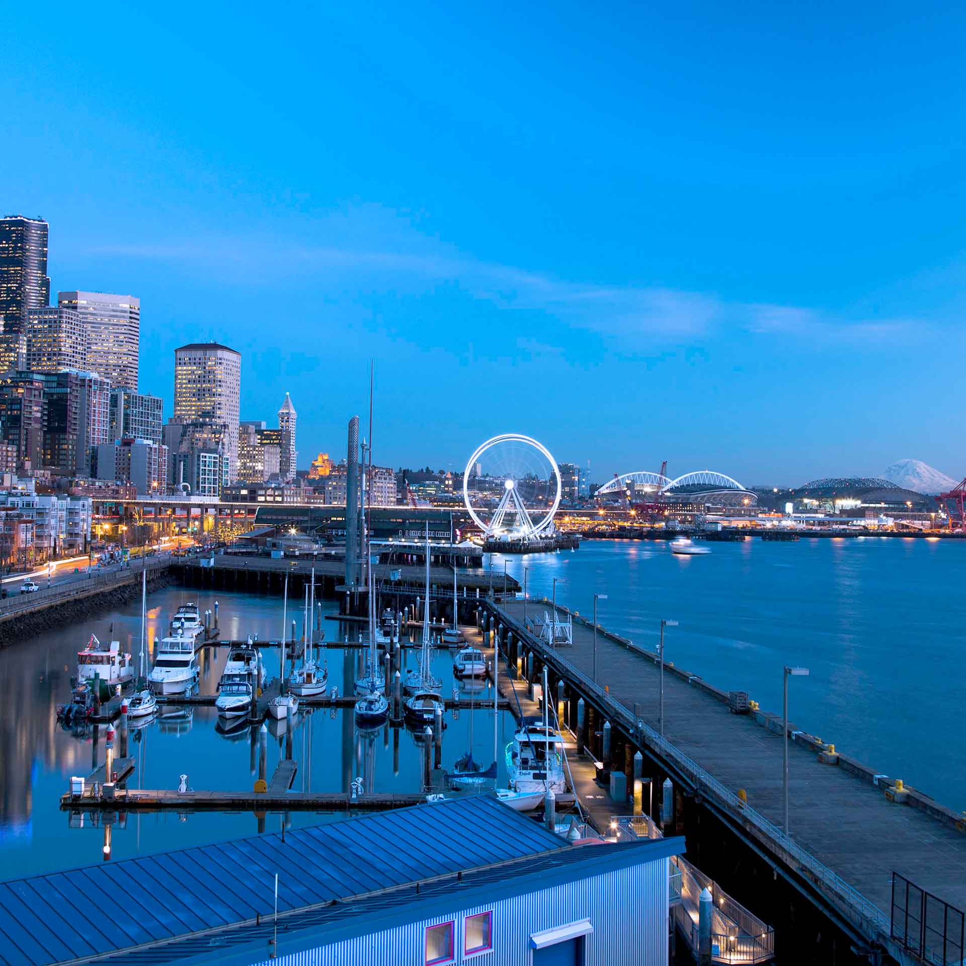 waterfront with buildings, water, and ferris wheel