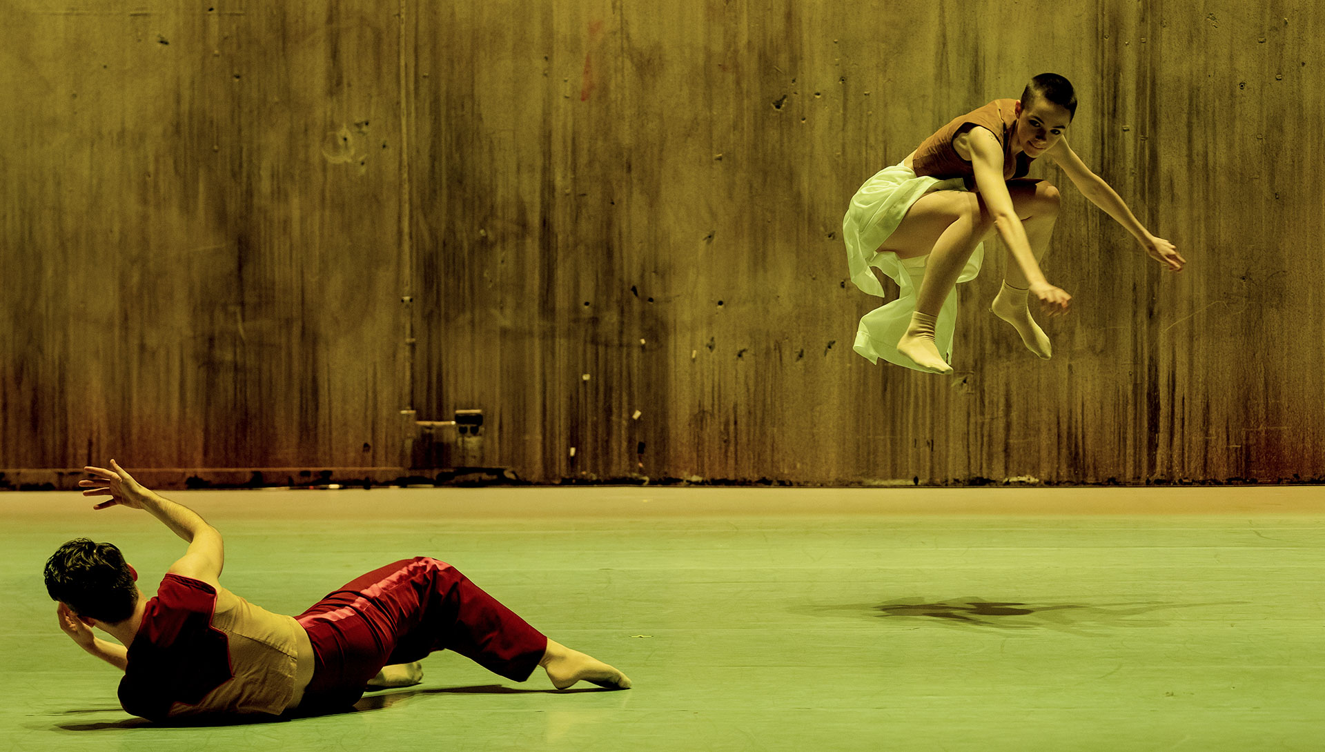 Two modern dancers performing on a stage