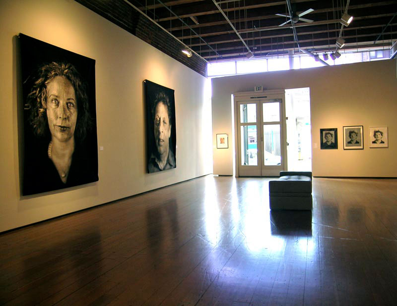 A gallery exhibit of portraits.