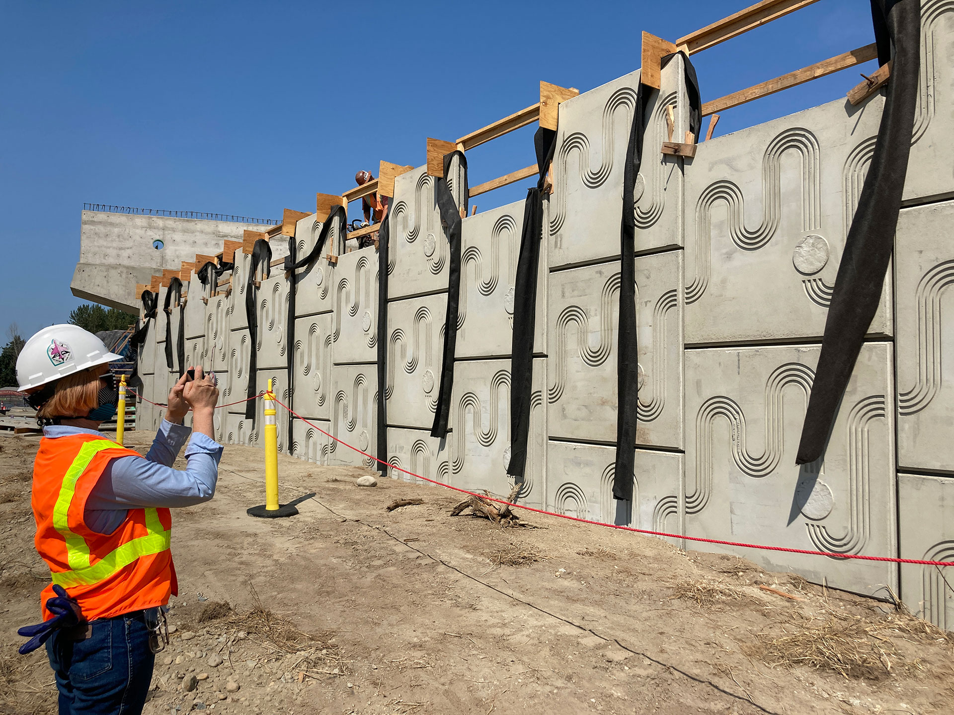 A person taking a photo of a public art installation.