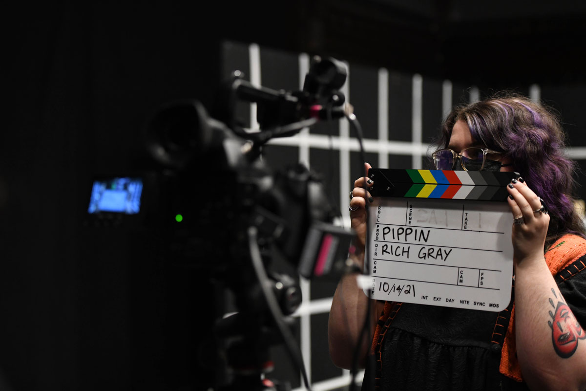 A person holding a clapboard.