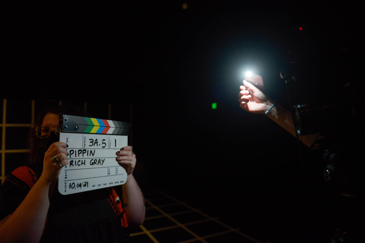 A person holding a clapboard.