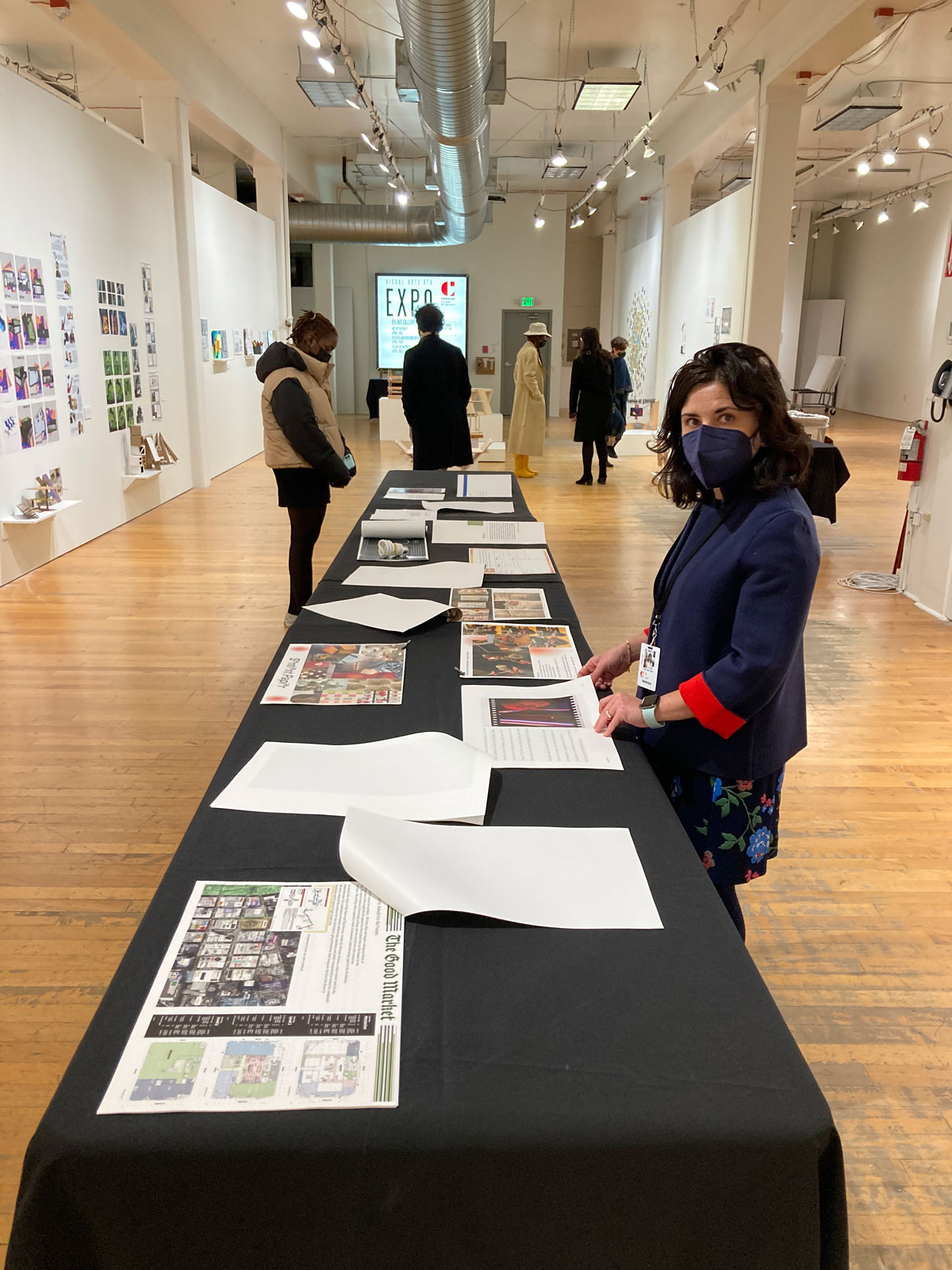 A person at a table in a gallery.