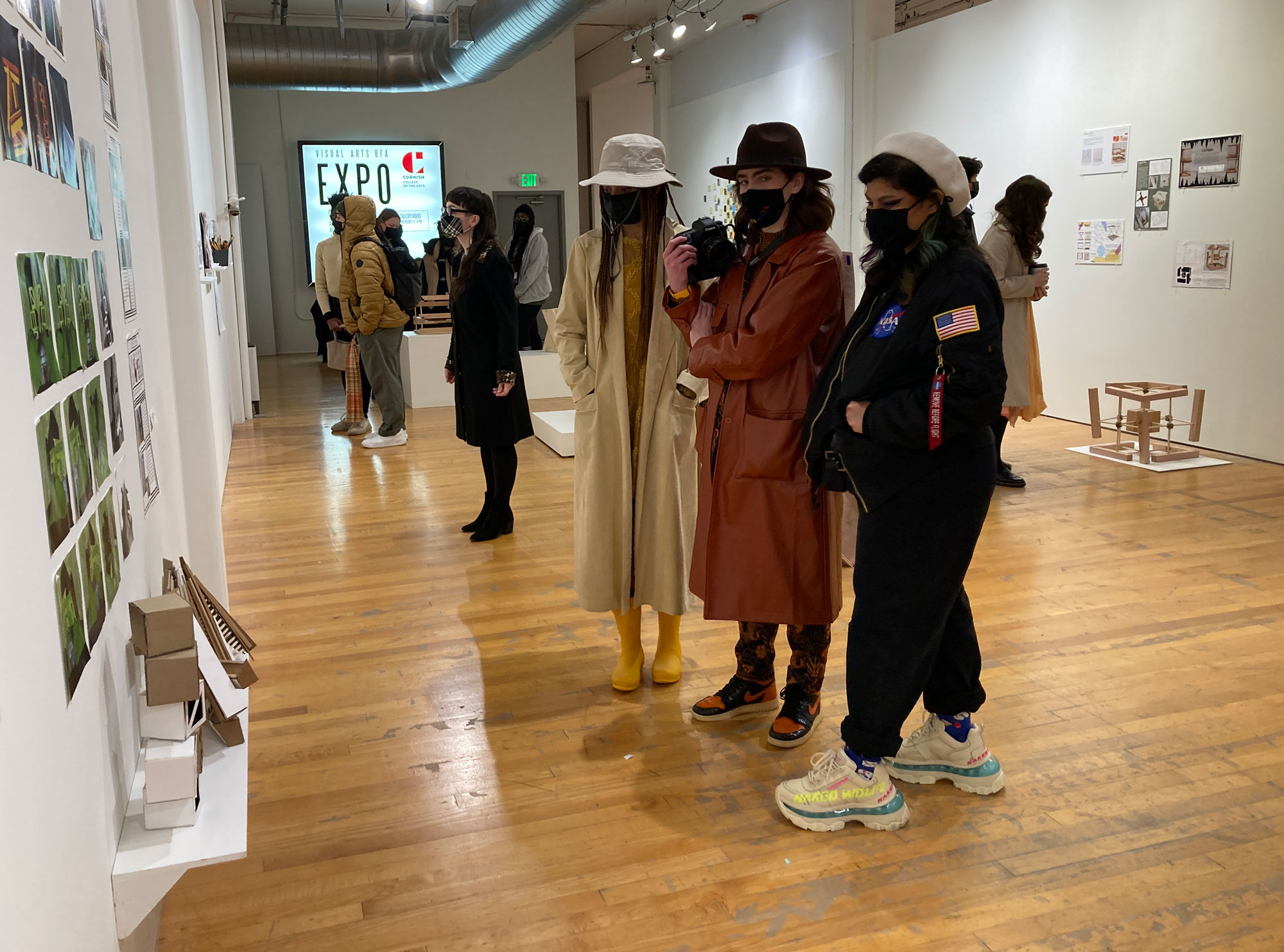 A group of people in a gallery.