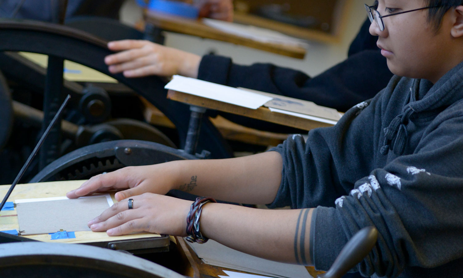 Students working in the print lab on presses