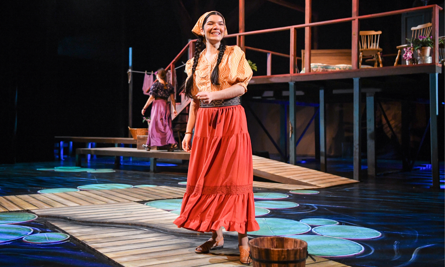 Performance of The River Bride at Cornish College of the Arts at Seattle University at the Cornish Playhouse. Actor stands on stage in spotlight midsong.