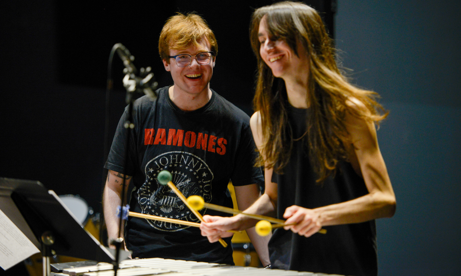 Photo of two musicians on stage performing together at the Raisbeck Auditorium