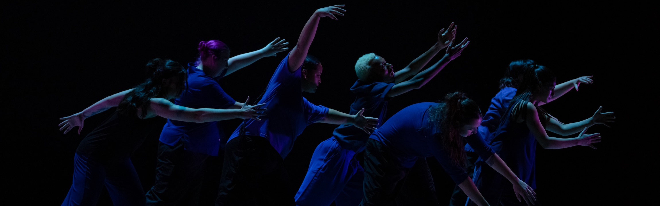 Fall Cornish Dance Theater photo by Joseph Hernandez. Dancers against a dark background in motion as a group.
