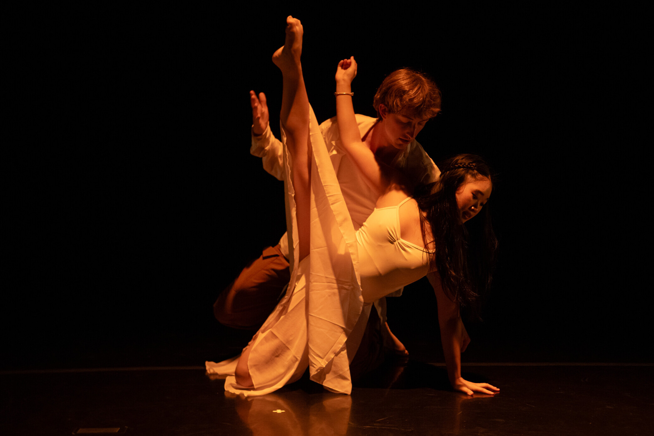 Photo by Joseph Hernandez from Cornish New Moves Fall 2025. Two dancers in a pose, both with one leg in the air.