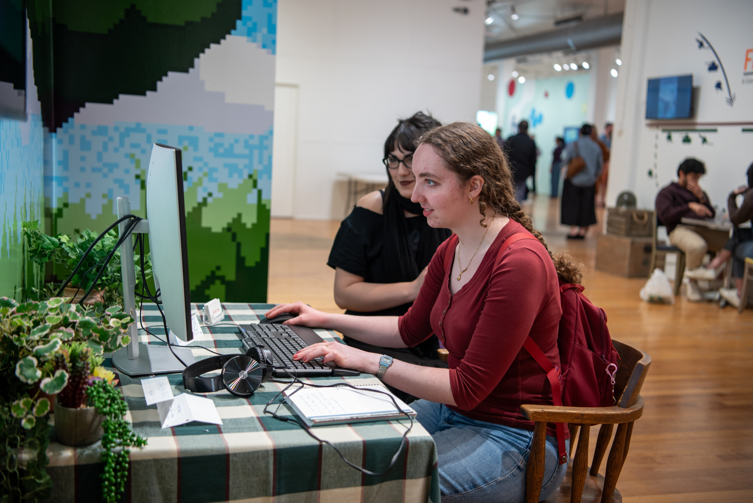 Two students playing a game at the 2026 Game Art BFA exhibition at Cornish College of the Arts. Photo by Winnie Westergard.