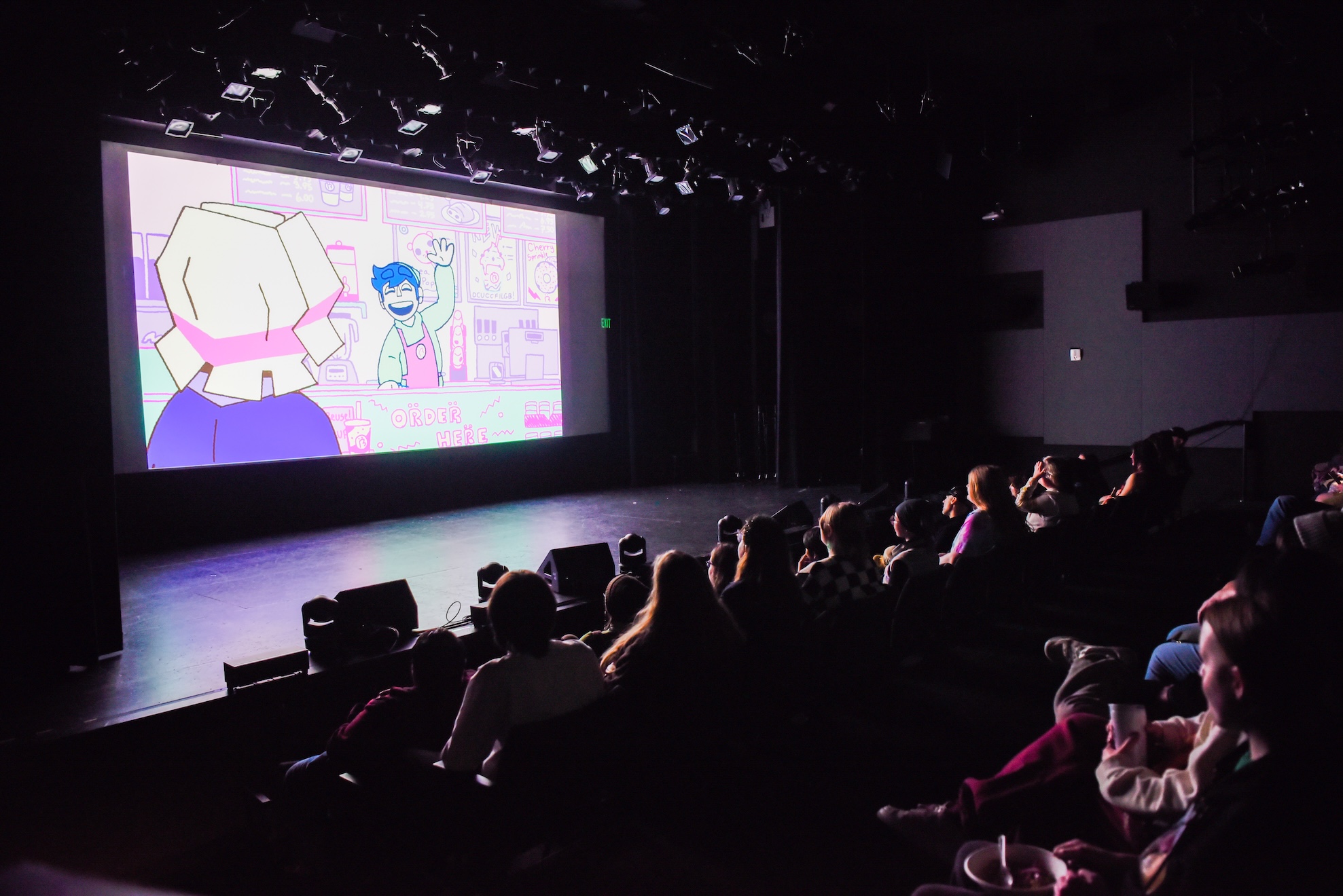 Screening of a short animated film at the Raisbeck Auditorium with an audience.