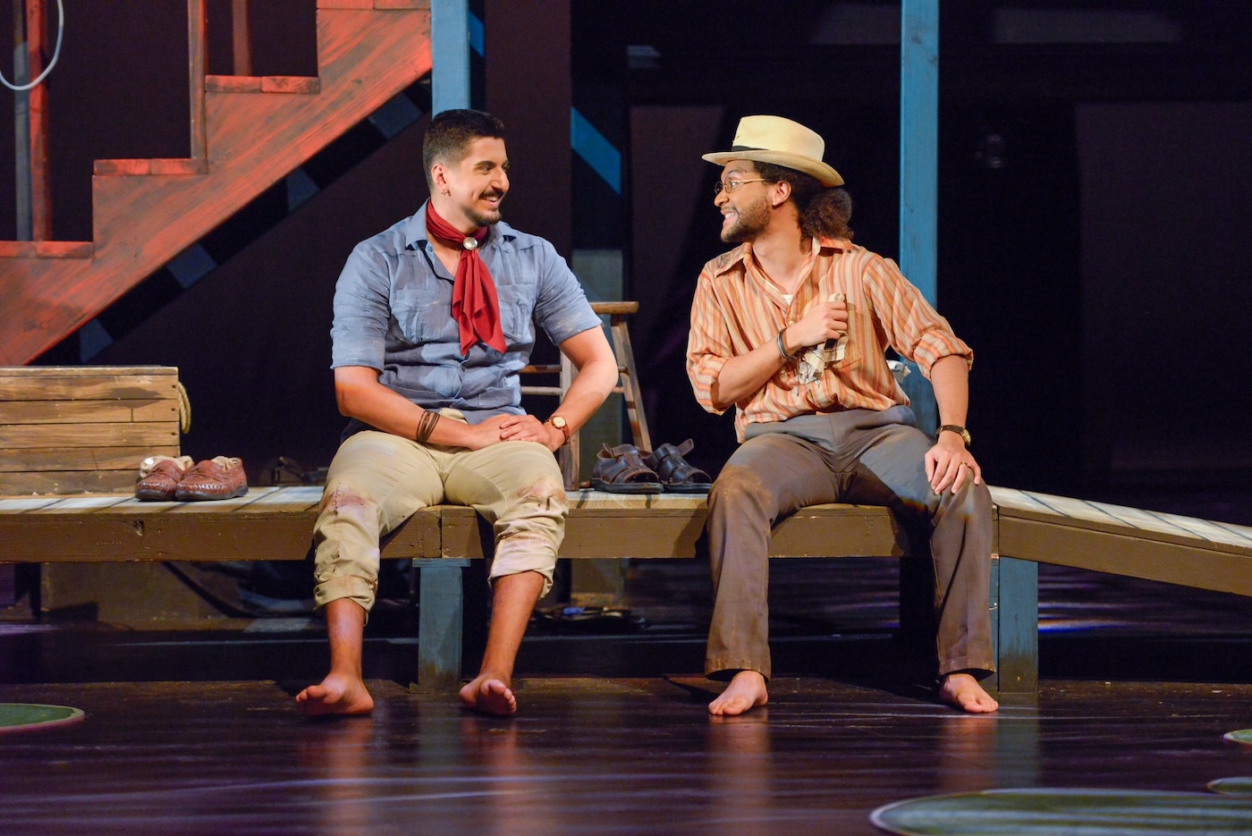 Scene from The River Bride; photo by Winnie Westergard. Two actors sit on a fake dock on stage.