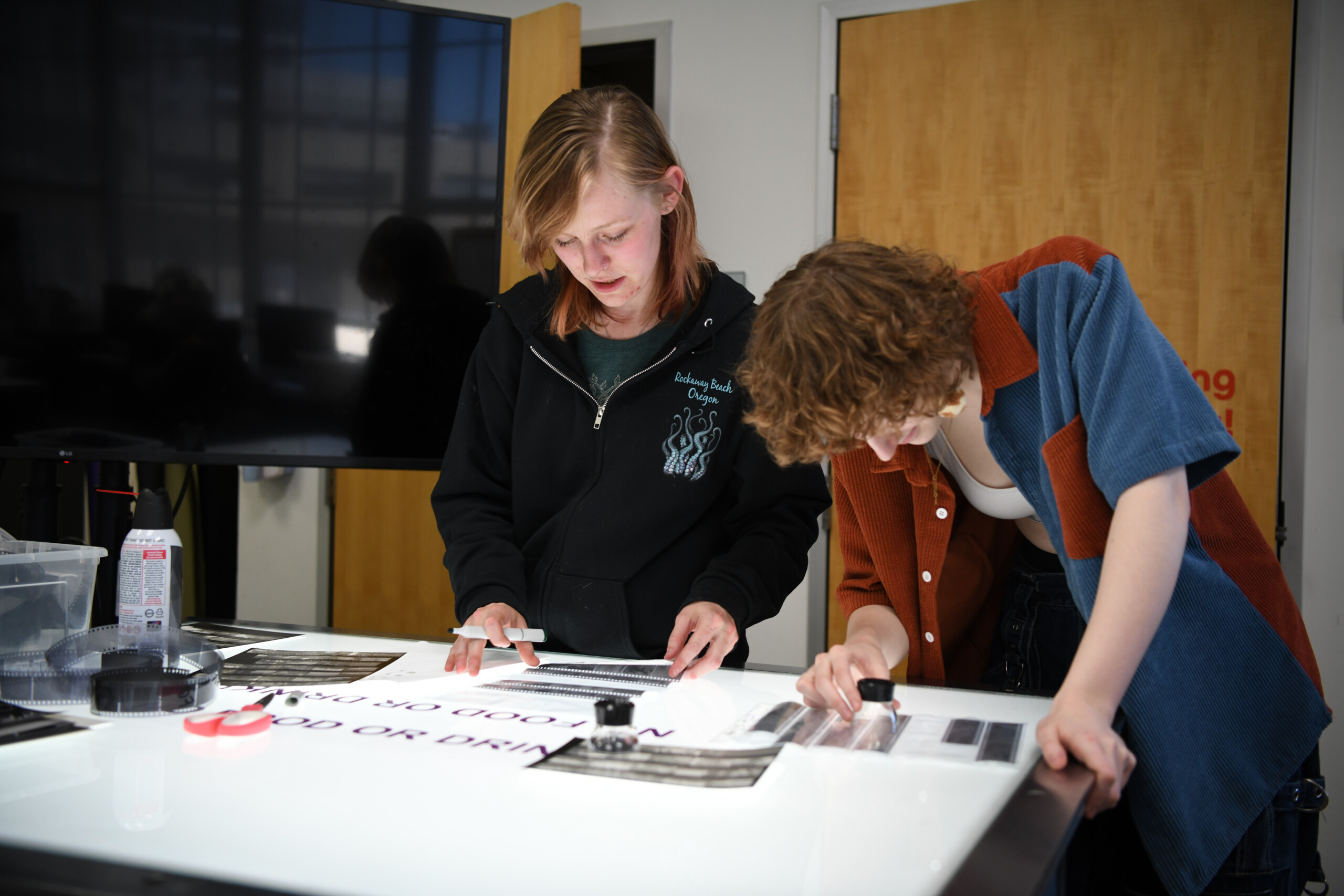 Photography students working at a Lightbox investigating film