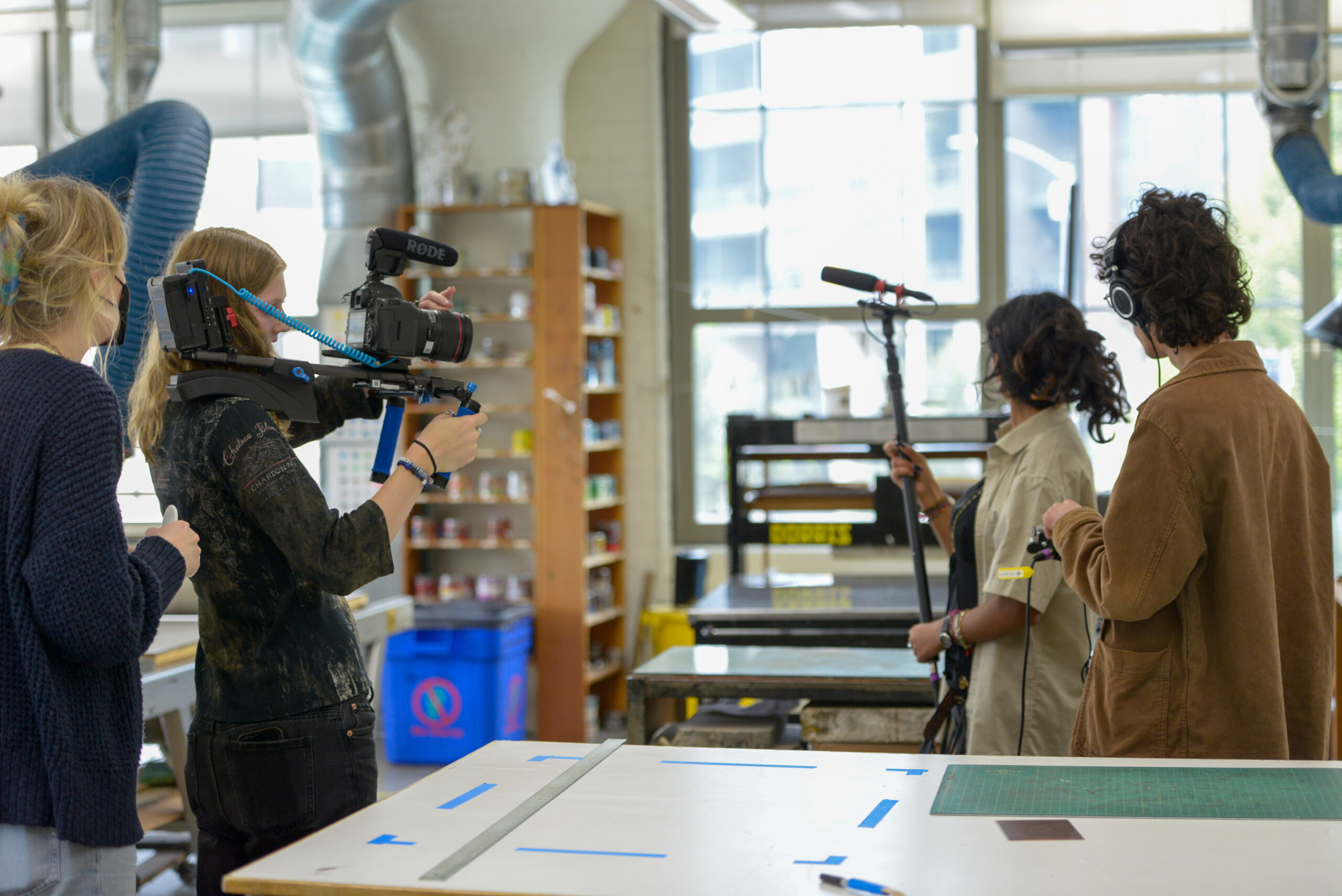 Students holding various camera equipment in the Cornish print studio.